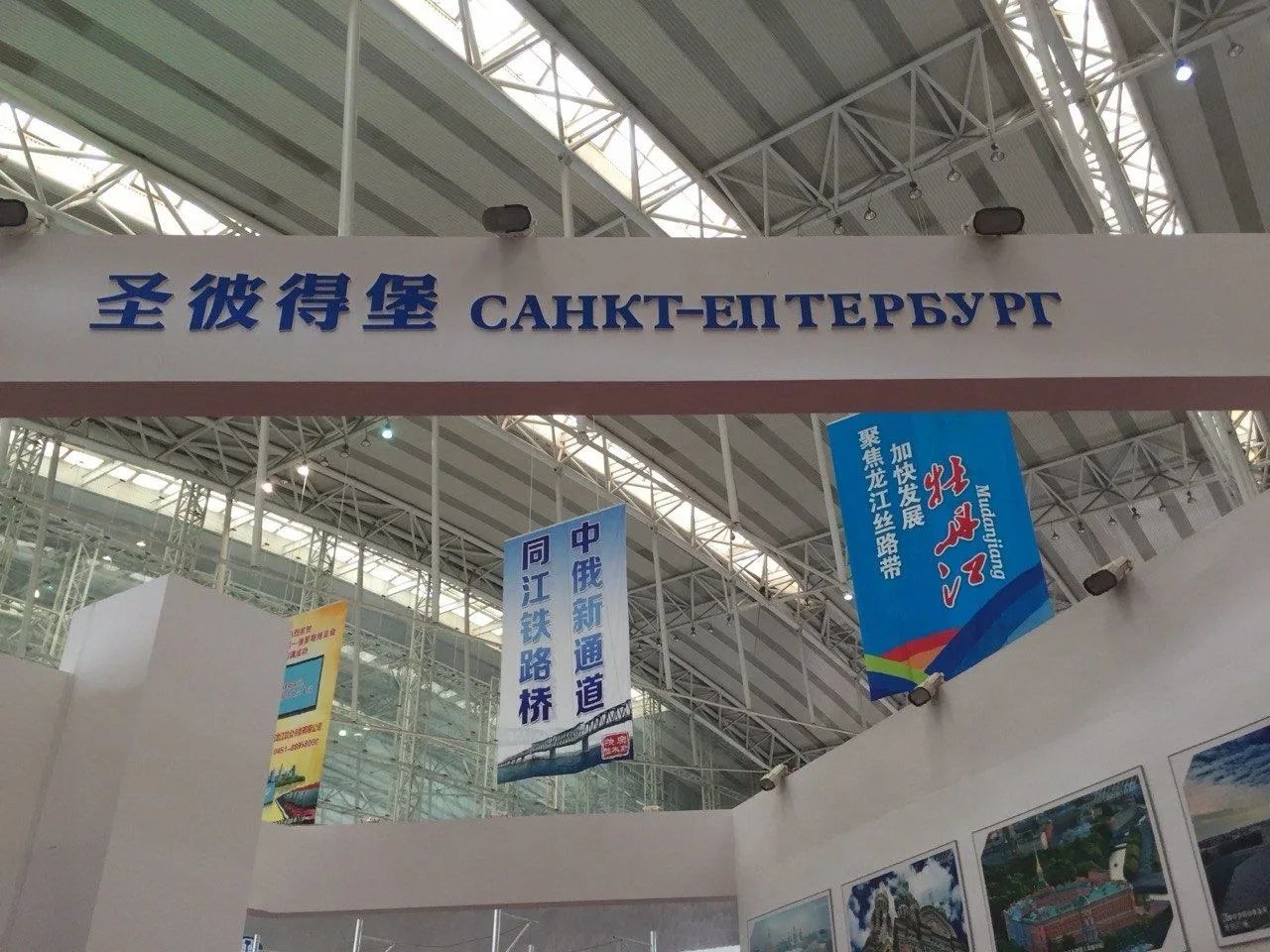 圣彼得堡 САНКТ-ПЕТЕРБУРГ. На заднем плане видны баннеры с китайским текстом, один из которых упоминает Муданьцзян и развитие, а другой – новый китайско-российский канал и железнодорожный мост Тунцзян.