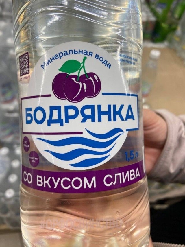 Минеральная вода Бодрянка 1,5 л СО ВКУСОМ СЛИВА. На этикетке изображены вишни, но указан вкус сливы. Также видны надписи: БЕЗ САХАРА, СОДЕРЖИТ СОК, напиток безалкогольный.