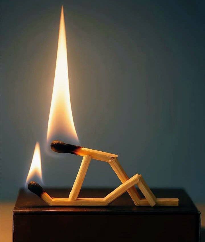 Фигура из спичек на подставке с горящей спичкой, создаёт миниатюрную скульптуру