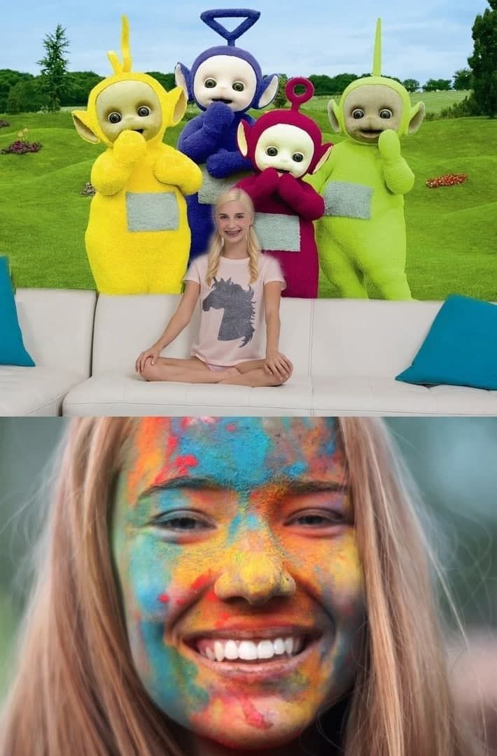Девочка сидит на диване перед фигурами Телепузиков на улице; лицо раскрашено яркими красками.