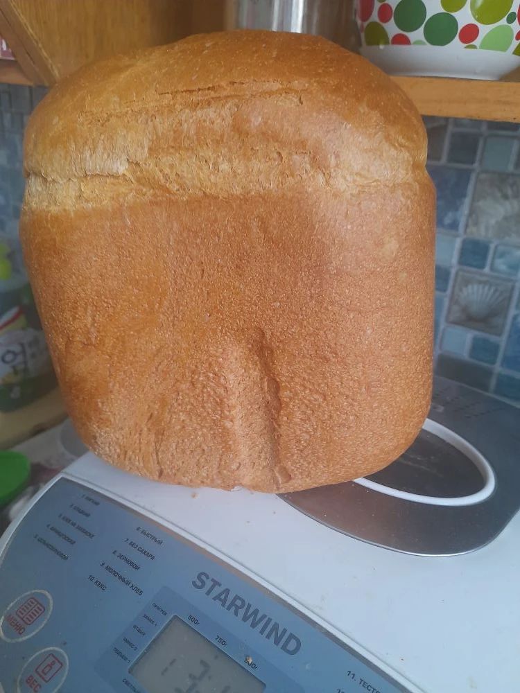 Большой хлеб на кухонной весах.