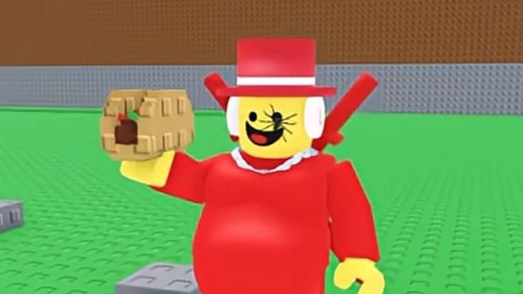 Игровой персонаж в красном костюме и цилиндре в окружении LEGO-подобной сцены.