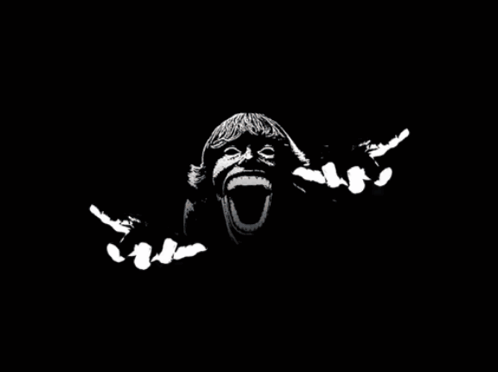 Черно-белый кадр: лицо с широко открытым ртом вылезает из темноты, руки вытягиваются вперед.